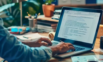 A person typing on a laptop, focused on creating email marketing campaigns for publishers